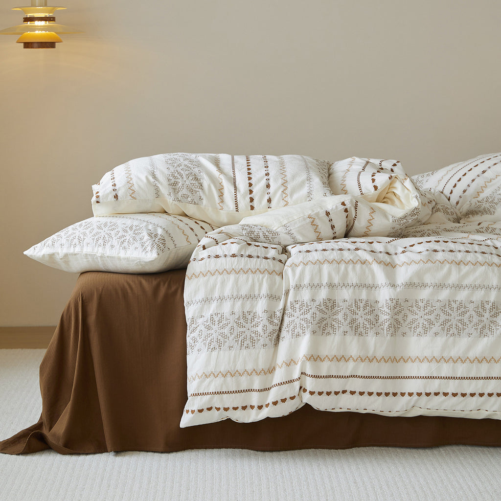 Close-up of the internal corner ties on a white cotton duvet cover, designed to secure the duvet insert.