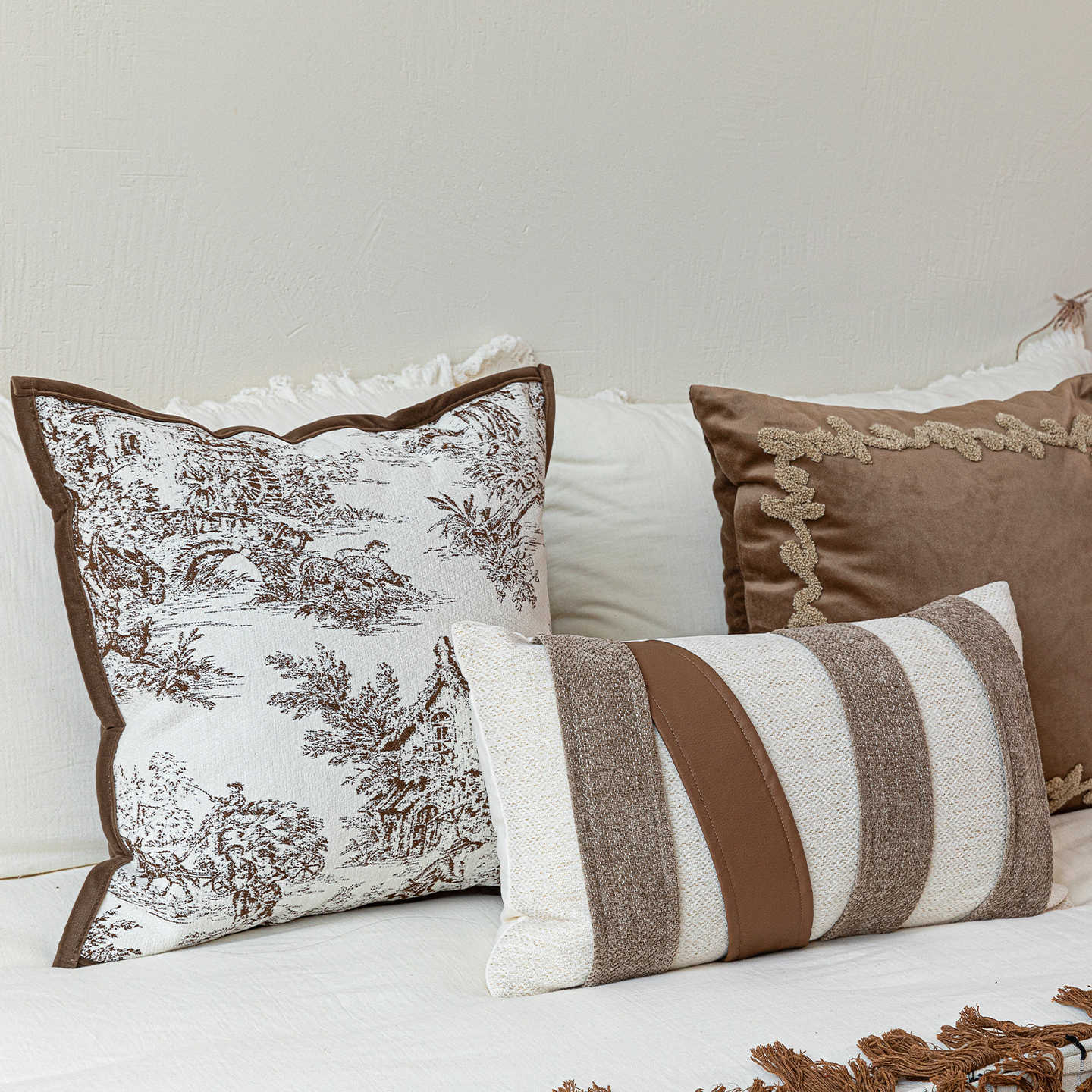 Cushion arrangement from the Heritage Atelier collection with patterned and embroidered designs.