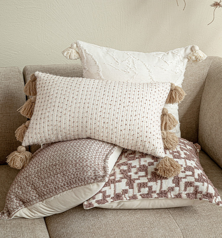 A curated group of artisanal pillows including a 30x50 lumbar and 45x45 square cushions in mauve and white, sold separately for custom layering.