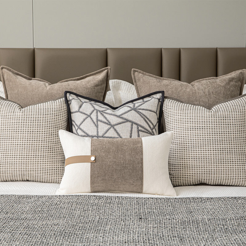 Layered neutral bedroom with textured pillowcases and woven graphite bed runner.