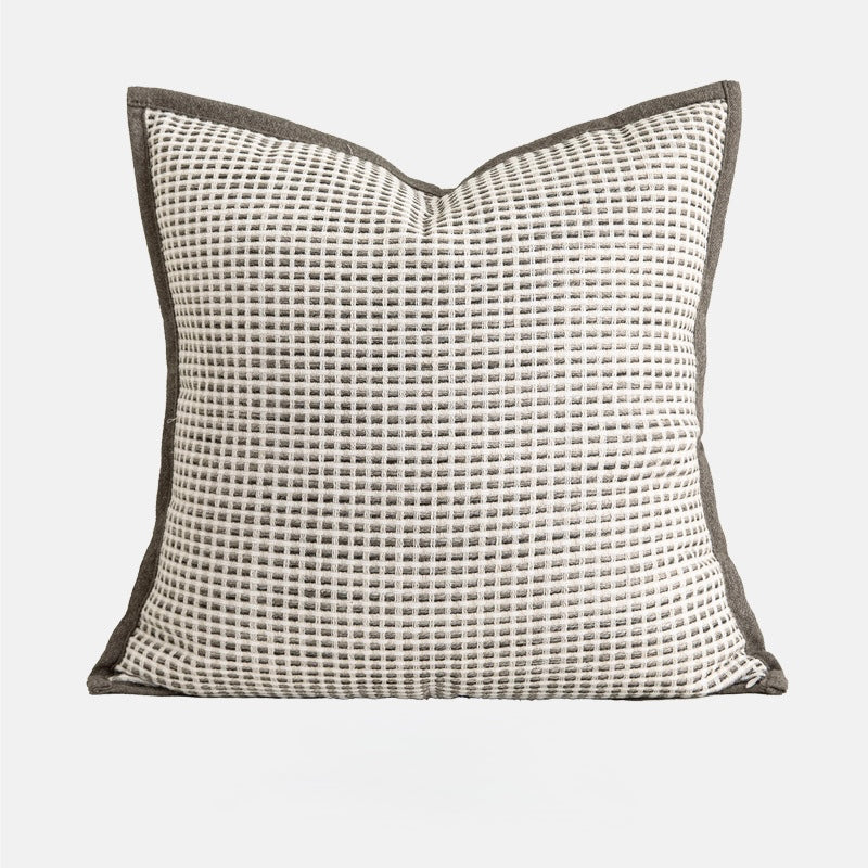 Textured grid pillowcase in soft neutral tones with woven surface detail.