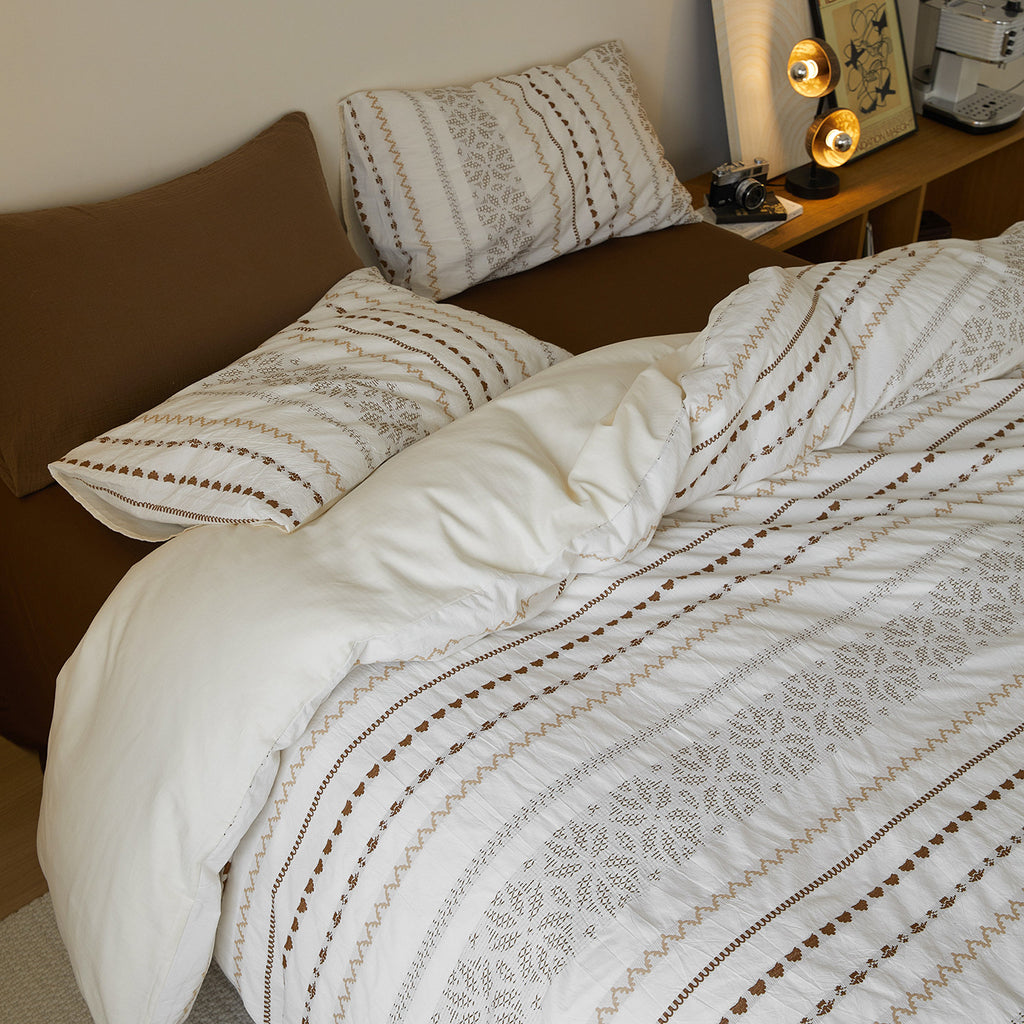 Low-angle close-up highlighting the "woven, not printed" texture of the damask and geometric motifs.